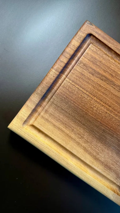 Holz Nussbaum Servierbrett mit Saftrille und elegantem Design auf einem Tisch